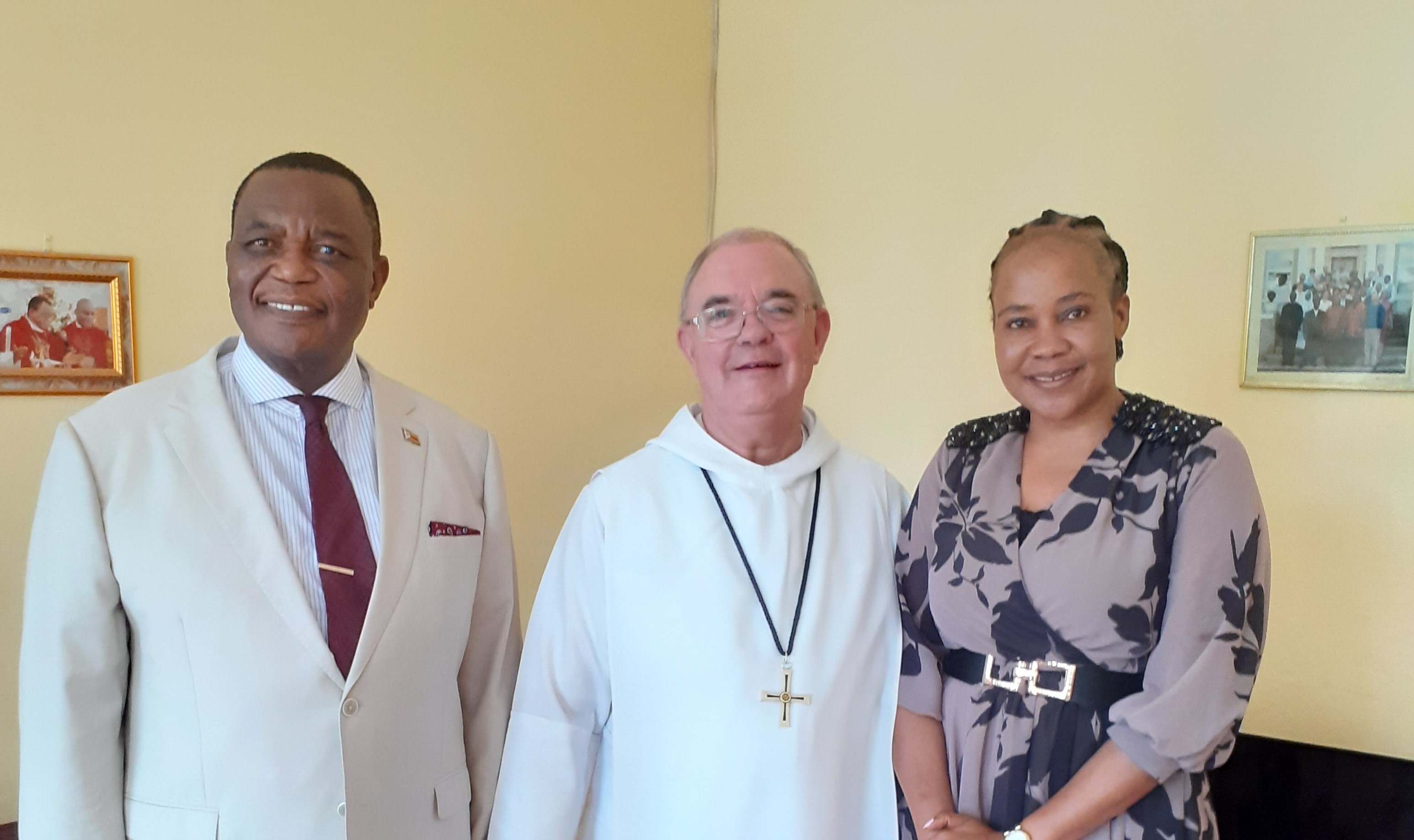 Abbot Robert stands in the middle of Dr Constantino Chiwenga and his wife