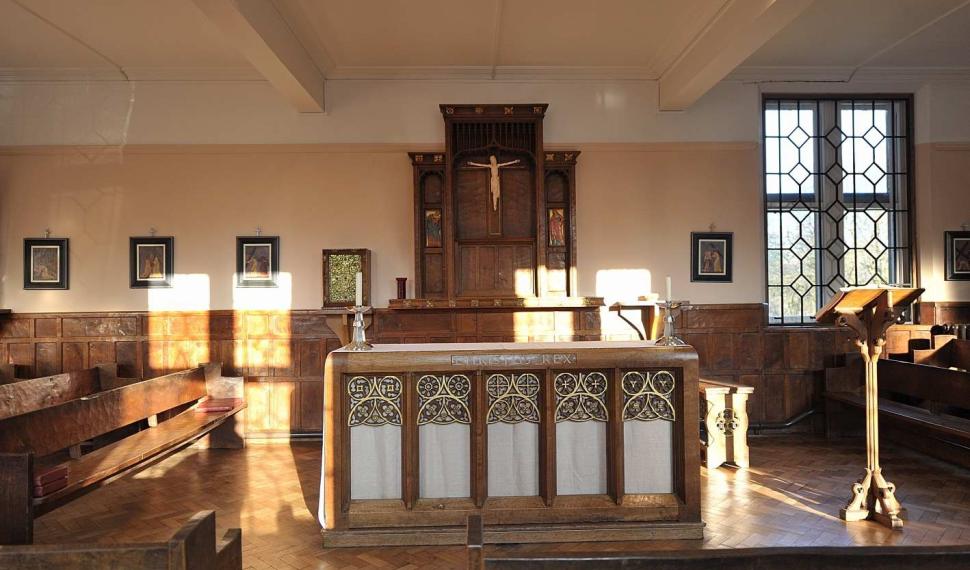 image of a chapel with wooden paneling and an altar