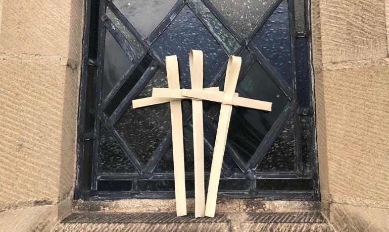 Palm Sunday crosses against stained glass window