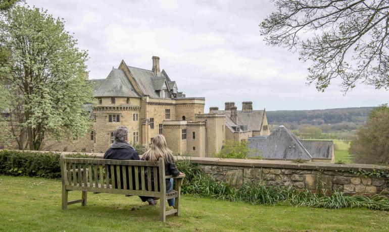 Two people sat on a bench outside The Grange