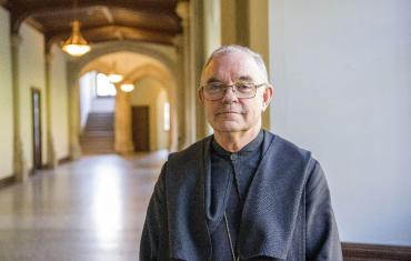 Abbot Robert in the monastery hallway